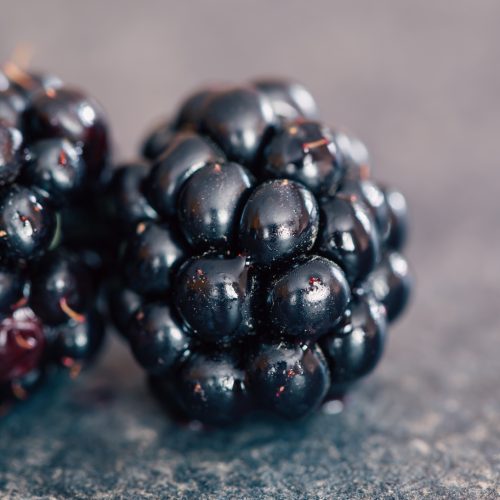 Blackberry berries on a blurred background, macro shot.